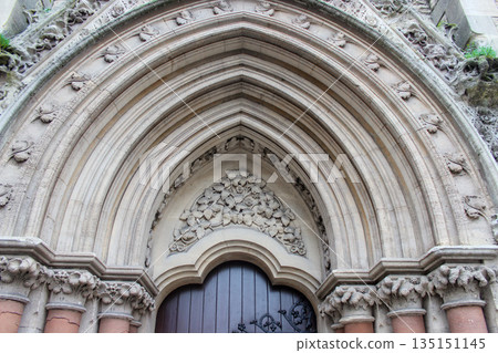 Oxford, United Kingdom - Dec 22, 2025: Wesley Memorial Church, a Methodist church in central Oxford. Tympanum above the entrance, decorated with stone carvings. Oxford, United Kingdom - Dec 22, 2025: Wesley Memorial Church, a Methodist church in central Oxford. Tympanum above the entrance, decorated with stone carvings. 135151145