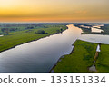 Lowland river IJssel through sunset landscape 135151334