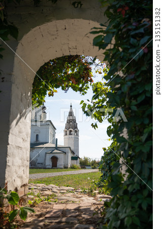 White Tower framed by white arch and climbing plants 135151382