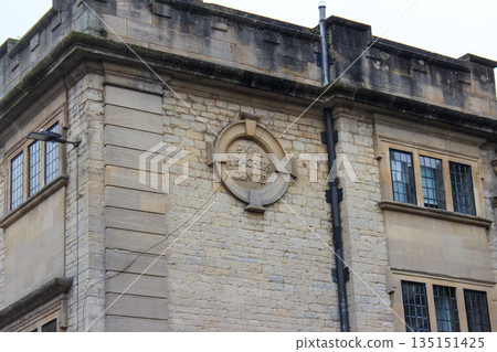 Oxford, United Kingdom - Dec 22, 2025: The old brick building with a round stone plaque on its facade. Inscription on the building remembering the Pupil Teachers Centre. Oxford, United Kingdom - Dec 22, 2025: The old brick building with a round stone plaque on its facade. Inscription on the building remembering the Pupil Teachers Centre. 135151425