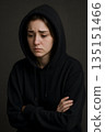 sad brunette girl in black sweatshirt. realistic photo of grief, depression, nervousness, tragic 135151466