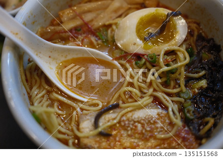 A delicious bowl of traditional Japanese ramen with pork, egg, noodles, and flavorful broth. A delicious bowl of traditional Japanese ramen with pork, egg, noodles, and flavorful broth. 135151568