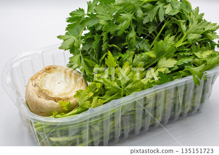 Fresh parsley with celery root closeup on white. 135151723