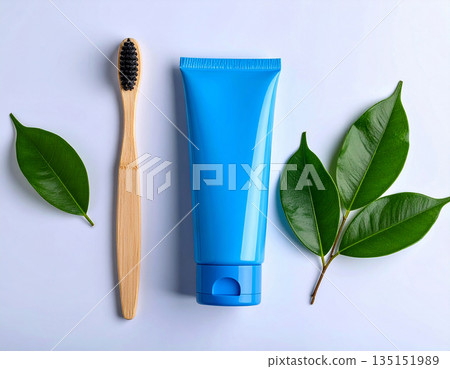 Healthy lifestyle appeal. Minimalistic bamboo toothbrush with a tube of natural toothpaste on a white background. Health care. Oral hygiene. 135151989