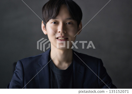 A man in his 20s smiling at the camera A man in his 20s smiling at the camera 135152071