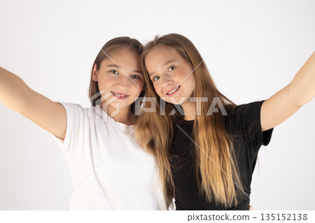 Two happy girls taking a selfie and smiling. 135152138