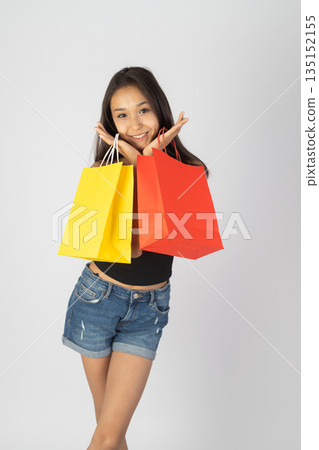 Happy girl holding colorful shopping bags. Happy girl holding colorful shopping bags. 135152155