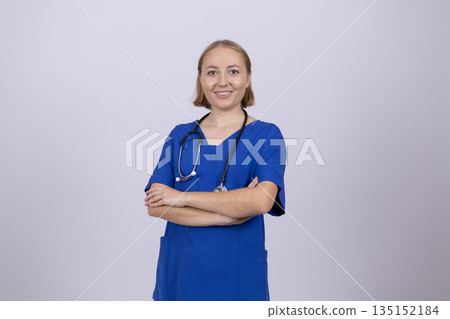 Confident female doctor standing with arms crossed. 135152184