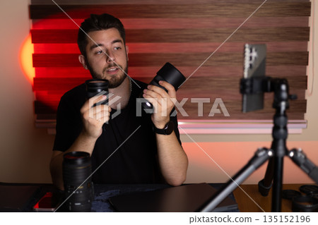 Vlogger with camera gear recording content in studio. Vlogger with camera gear recording content in studio. 135152196