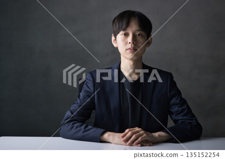 A man in his 20s with a serious expression looking straight at the camera A man in his 20s with a serious expression looking straight at the camera 135152254