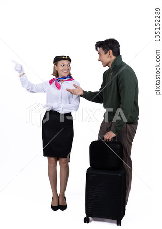 Stewardess helping a passenger with his luggage. 135152289
