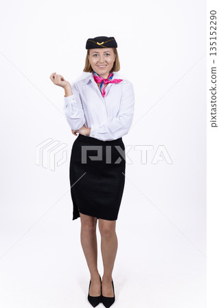 Flight attendant in uniform making a greeting gesture. 135152290