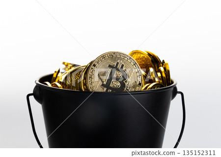Bucket filled with golden bitcoin coins on white background. Bucket filled with golden bitcoin coins on white background. 135152311