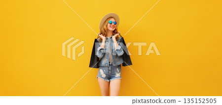 Shopping day, stylish beautiful happy smiling young woman with black shopping bags, wear summer hat 135152505
