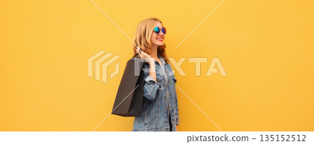 Shopping day, stylish happy smiling young woman with black shopping bags 135152512