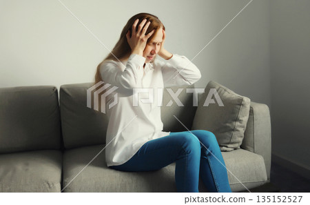 Exhausted tired woman suffering from headache, stress, fatigue, temples pain, migraine, loud noise Exhausted tired woman suffering from headache, stress, fatigue, temples pain, migraine, loud noise 135152527