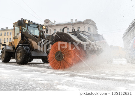 Snowplow truck vehicle removing snow after blizzard and snowstorm. Snowfall at European city Snowplow truck vehicle removing snow after blizzard and snowstorm. Snowfall at European city 135152621