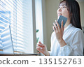 Business woman operating a smartphone Business woman operating a smartphone 135152763