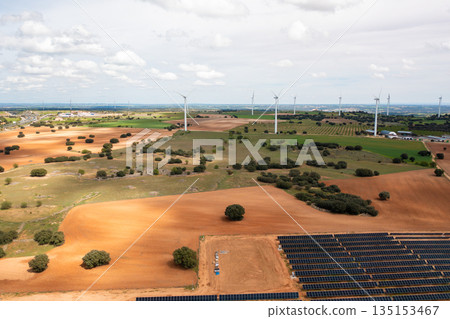 Aerial view of wind turbines and solar panels on 135153467