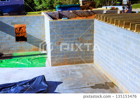 Construction of concrete block walls for new building beams trusses Construction of concrete block walls for new building beams trusses 135153476