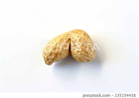 Unusually shaped peanuts on a white background viewed from directly above 135154438