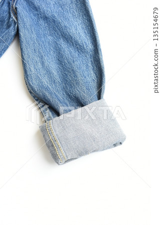 roll up sleeve of blue denim shirt texture isolated on white background, jean fashion style 135154679