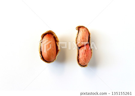 Cracked peanuts on a white background, viewed from directly above Cracked peanuts on a white background, viewed from directly above 135155261