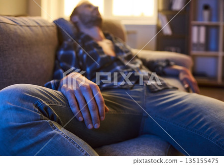 Man with depression from drugs addiction and fatigue lying on living room sofa Man with depression from drugs addiction and fatigue lying on living room sofa 135155475