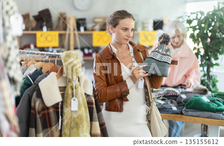 During November sales, woman choose and buy hat 135155612