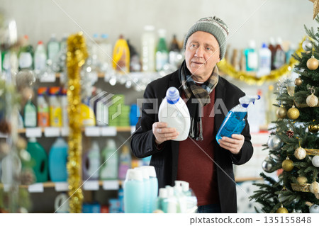 Elderly man choosing detergent and spray Elderly man choosing detergent and spray 135155848