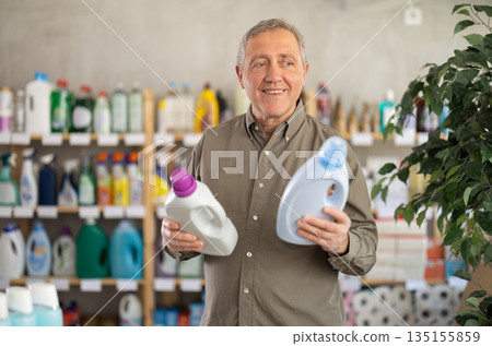 Elderly man choosing cleaning product in supermarket Elderly man choosing cleaning product in supermarket 135155859