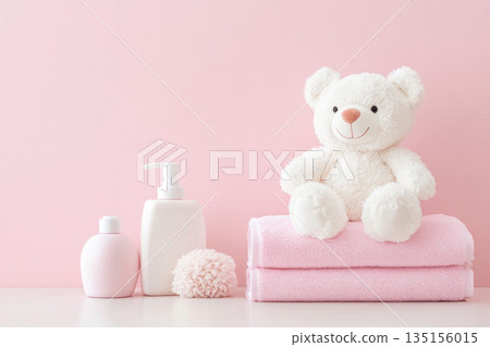 Baby bath accessories, bottles of shampoo with teddy bear and pink towels 135156015