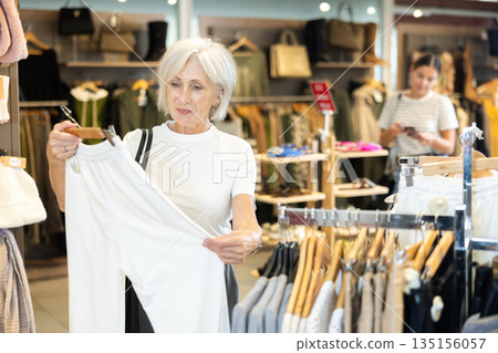 She peruses store for perfect pair of trousers 135156057