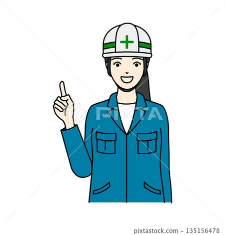 A woman in work clothes wearing a helmet and pointing with a smile 135156478