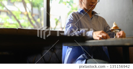 Woman by the window and parfait 135156942