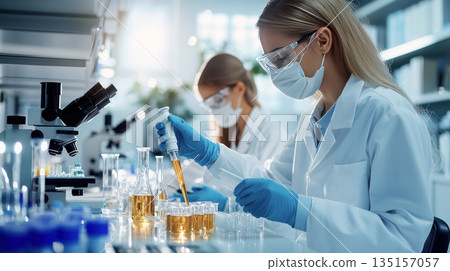 Doctor or researcher examines a sample, their expression focused and determined Doctor or researcher examines a sample, their expression focused and determined 135157057