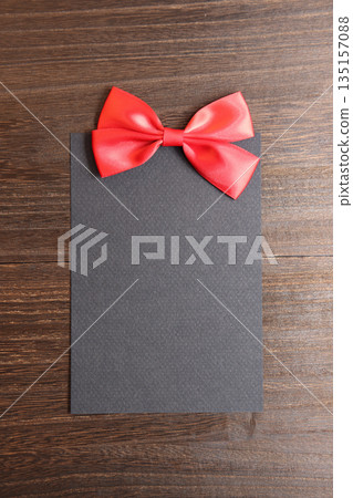 Black message card and red ribbon 135157088