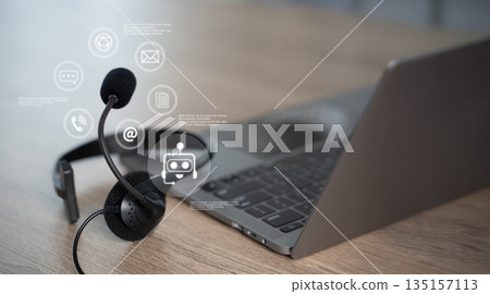 Customer support headset on desk with laptop and online chat interface, help desk communication and AI chatbot service concept for business technology in modern office, copy space. 135157113
