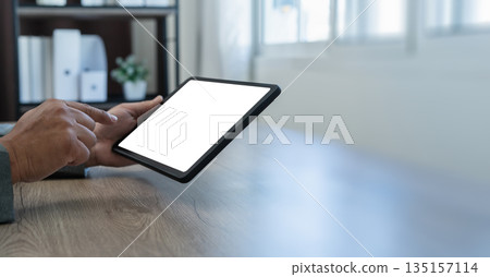 man using businessman holds a mockup holding blank screen tablet Mockup replaces your design mockup in the office 135157114