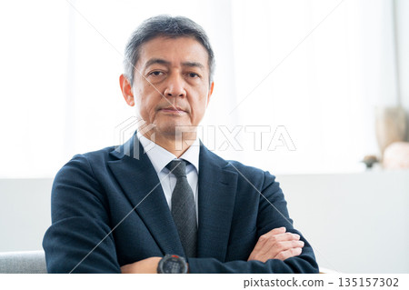 Senior businessman with his arms crossed and looking confident Senior businessman with his arms crossed and looking confident 135157302