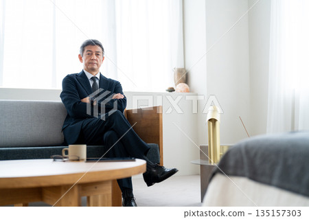Senior businessman with his arms crossed and looking confident 135157303