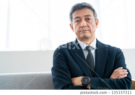 Senior businessman with his arms crossed and looking confident Senior businessman with his arms crossed and looking confident 135157311