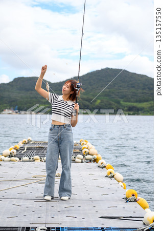 A woman fishing on a pier (Photo courtesy of Oki Seaside Resort Miyabi) A woman fishing on a pier (Photo courtesy of Oki Seaside Resort Miyabi) 135157550