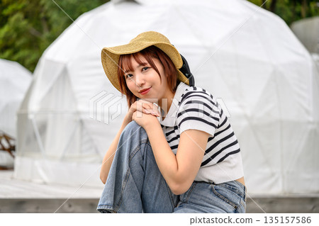 A smiling woman in a straw hat [Photography cooperation: Oki Seaside Resort Miyabi] 135157586