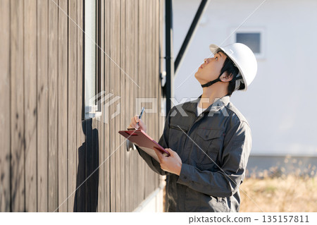 Site supervisor checking the exterior wall 135157811
