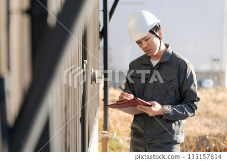 Site supervisor checking the exterior wall Site supervisor checking the exterior wall 135157814