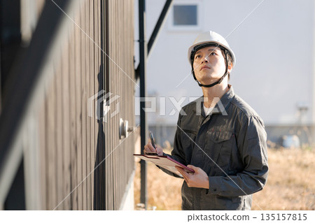 Site supervisor checking the exterior wall Site supervisor checking the exterior wall 135157815