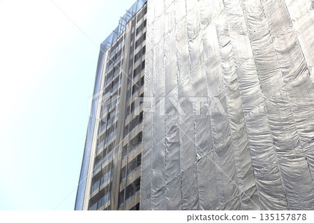 Scaffolding for repair work on the exterior walls of a high-rise apartment building Scaffolding for repair work on the exterior walls of a high-rise apartment building 135157878