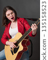 Passionate woman, talented guitarist singer songwriter, performs with incredible heart and soul. Young woman instrumentalist plays guitar, sings rock music, her performance is full of life and energy Passionate woman, talented guitarist singer songwriter, performs with incredible heart and soul. Young woman instrumentalist plays guitar, sings rock music, her performance is full of life and energy 135158523