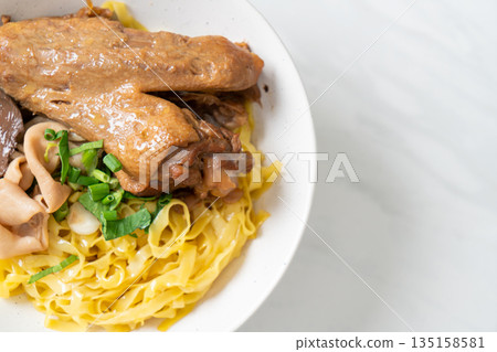 Egg noodles served dry with braised duck 135158581